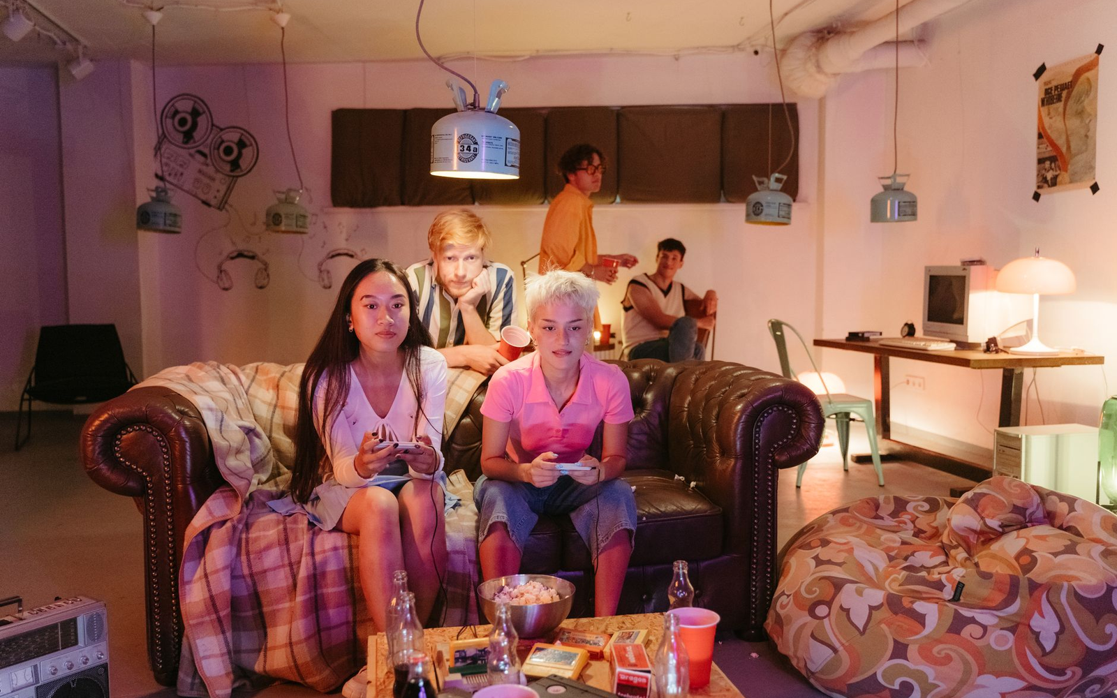 Small group of adult guests around a compact entertainment table in a warm private lounge
